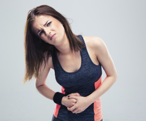 Fitness woman having pain in stomach